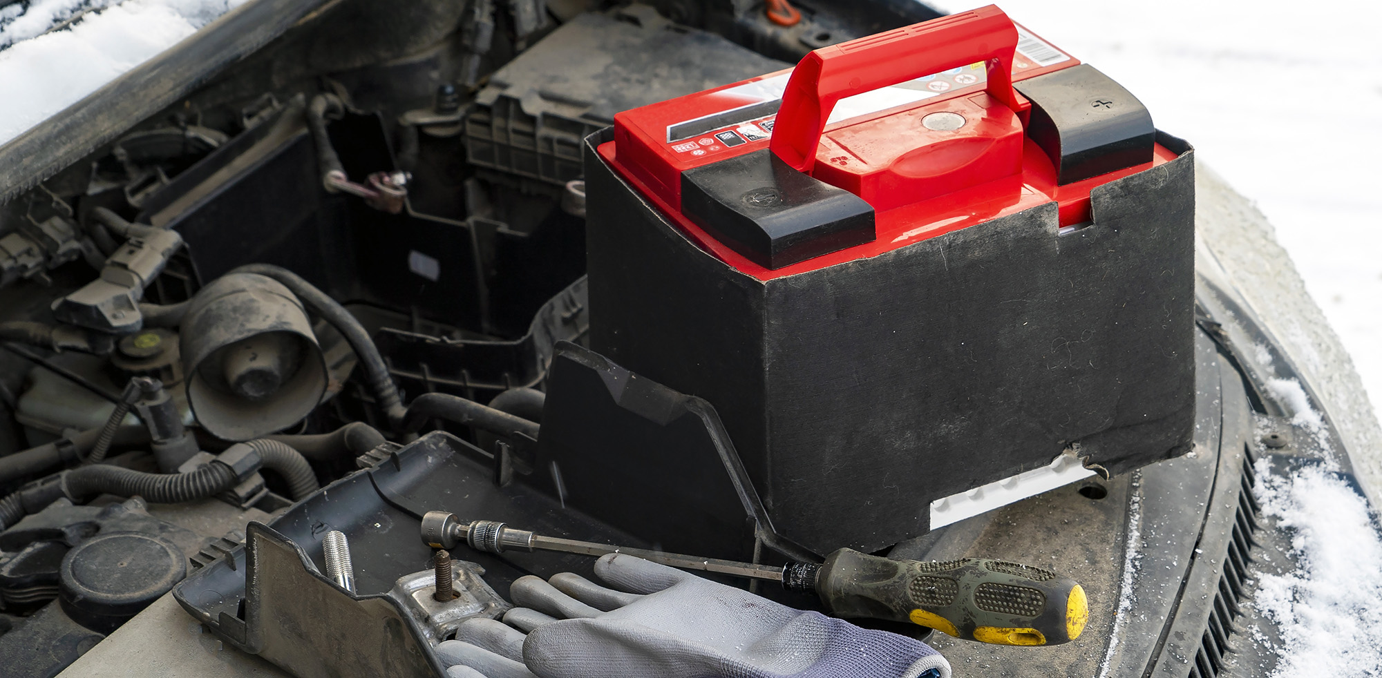 Eine neue Autobatterie wird im Winter eingebaut Eine neue Autobatterie wird im Winter eingebaut